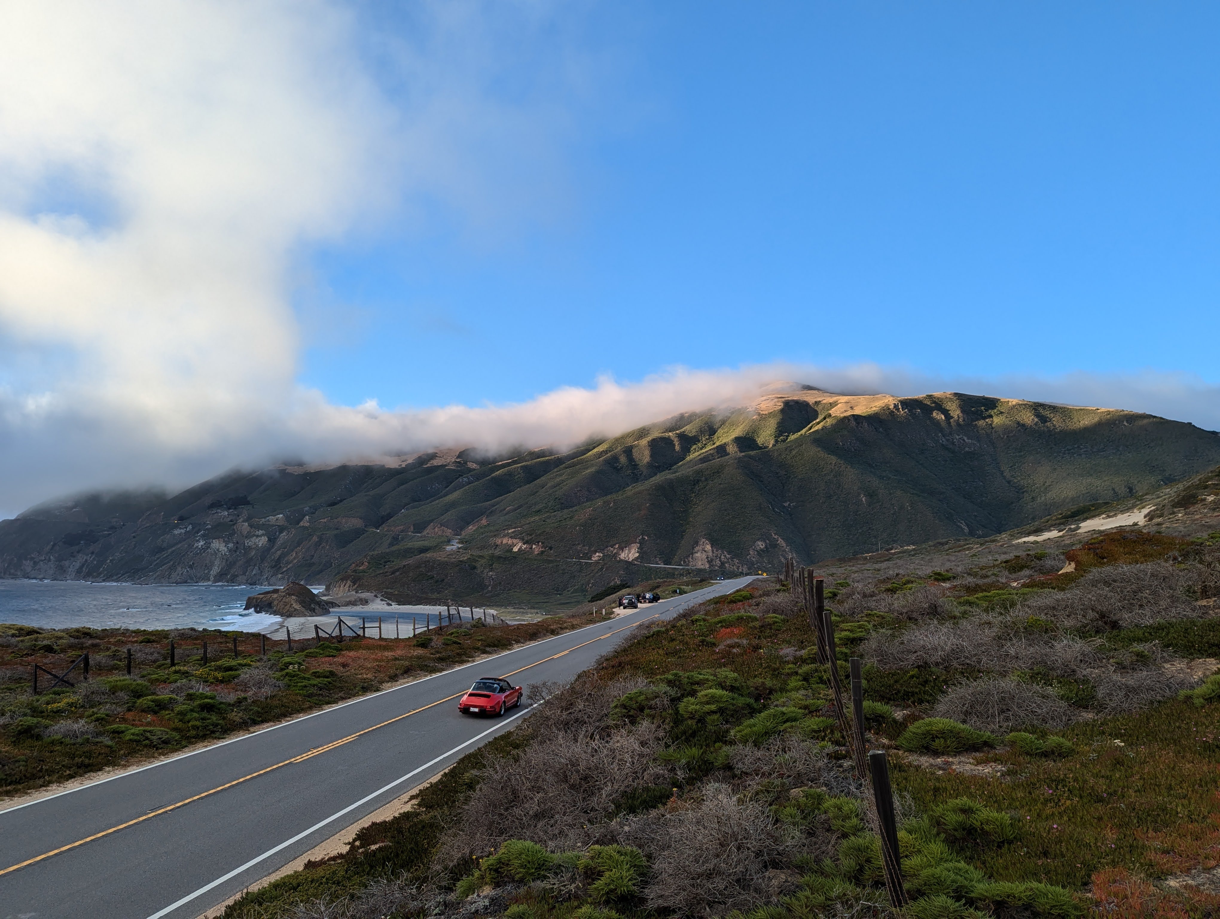 Big Sur coastal road with mountains